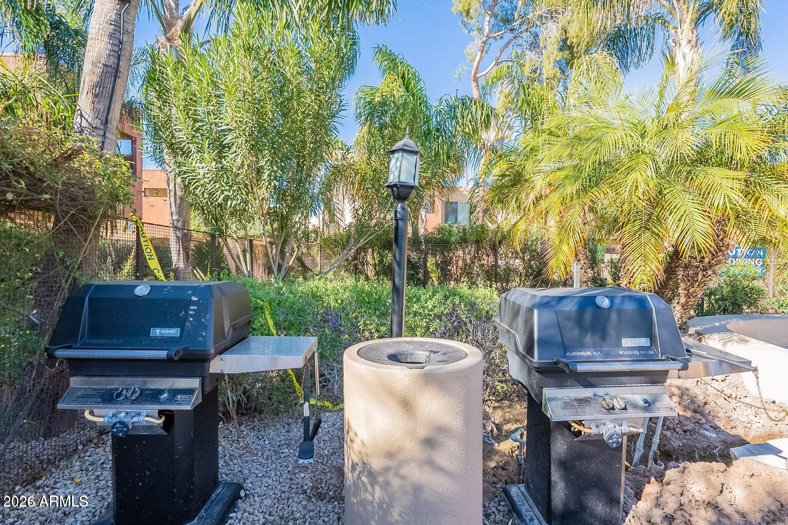 3600 North Hayden Road, Unit 3410 Scottsdale, AZ 85251 - Photo 12 of 22 a view of a backyard with table and chairs potted plants and large tree