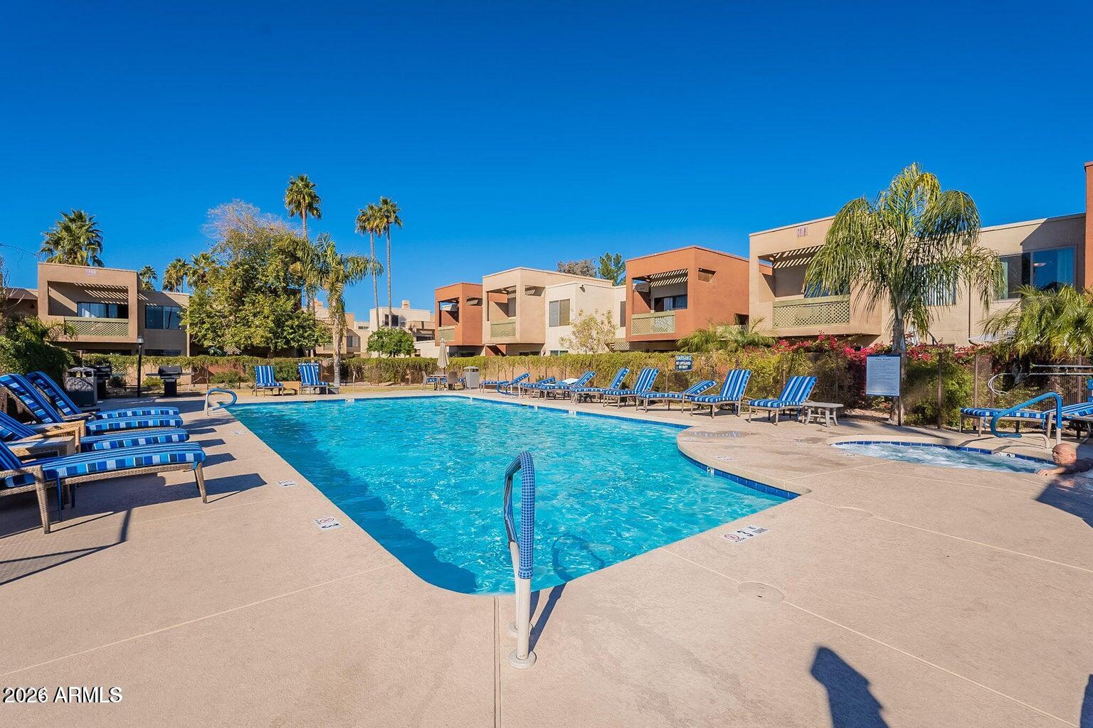 3600 North Hayden Road, Unit 3410 Scottsdale, AZ 85251 - Photo 18 of 22 a view of a swimming pool with a lounge chairs