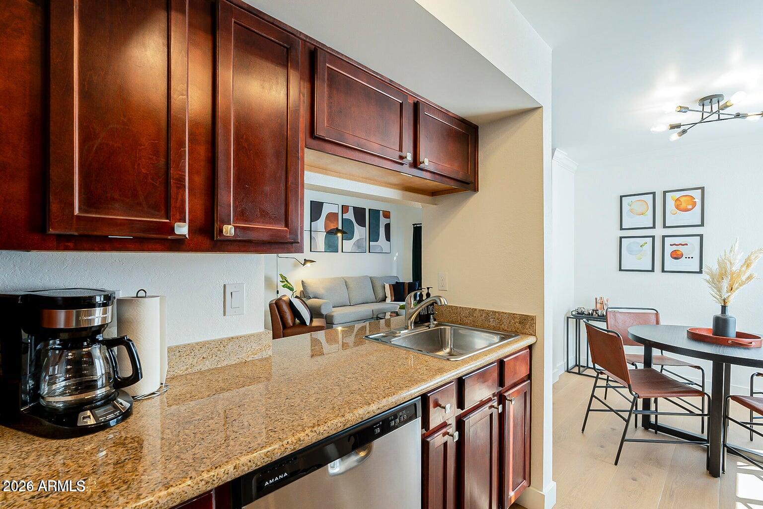 3600 North Hayden Road, Unit 3410 Scottsdale, AZ 85251 - Photo 2 of 22 a kitchen with a sink a stove and cabinets