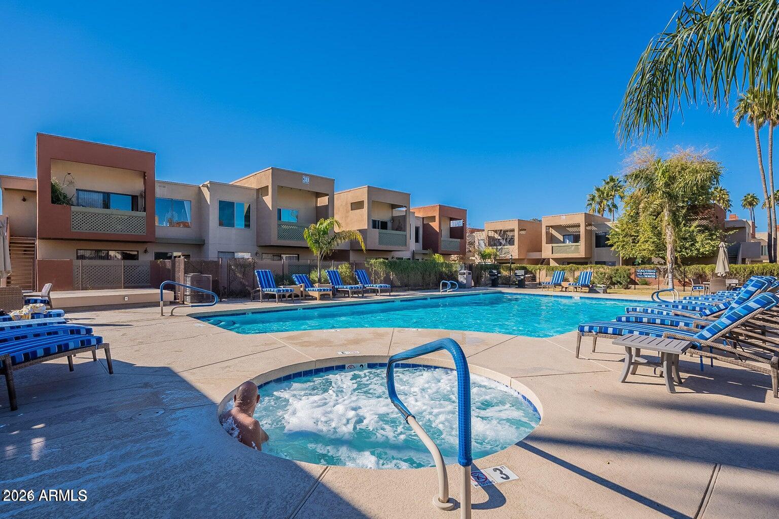 3600 North Hayden Road, Unit 3410 Scottsdale, AZ 85251 - Photo 21 of 22 a swimming pool with outdoor seating and yard