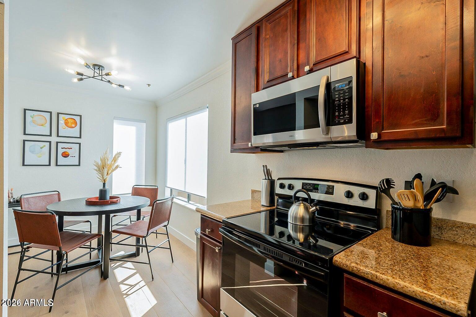 3600 North Hayden Road, Unit 3410 Scottsdale, AZ 85251 - Photo 4 of 22 a kitchen with a stove and a microwave