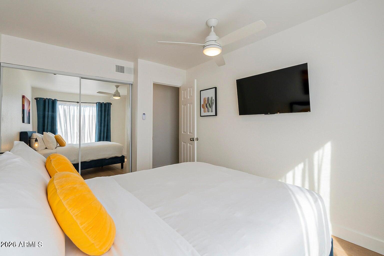 3600 North Hayden Road, Unit 3410 Scottsdale, AZ 85251 - Photo 7 of 22 a bedroom with a bed and a flat screen tv
