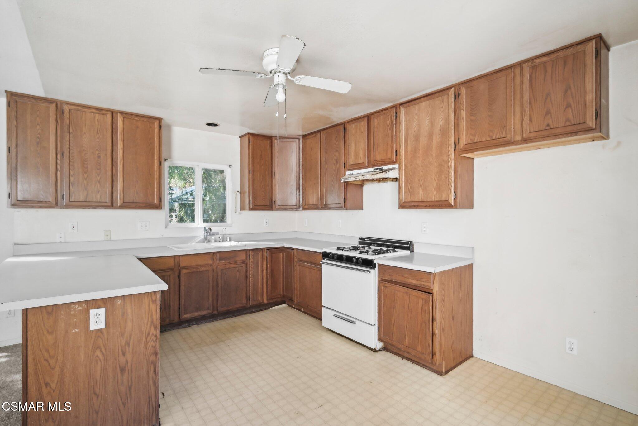 1068 Alta Vista Road Simi Valley, CA 93063 - Photo 4 of 16 a kitchen with stainless steel appliances granite countertop a sink stove and refrigerator