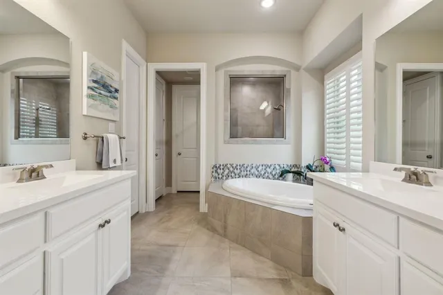 a spacious bathroom with a double vanity sink mirror double
