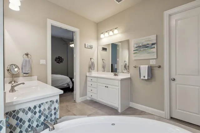 a spacious bathroom with a double vanity sink mirror and toilet