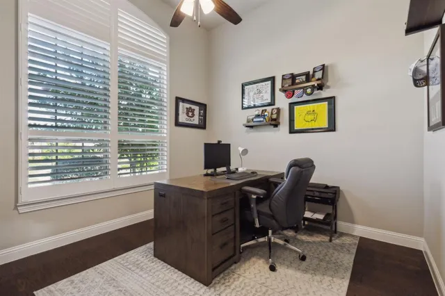 a view of a workspace with furniture and a window