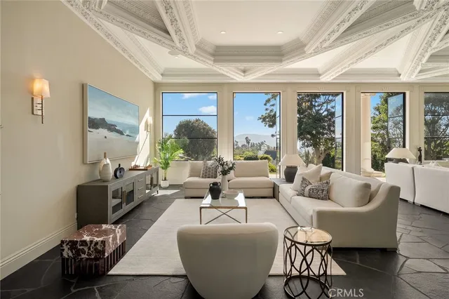 a living room with furniture a fireplace and a large window