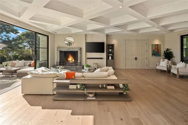 a large kitchen with kitchen island a stove a sink a refrigerator and a dining table with wooden floor