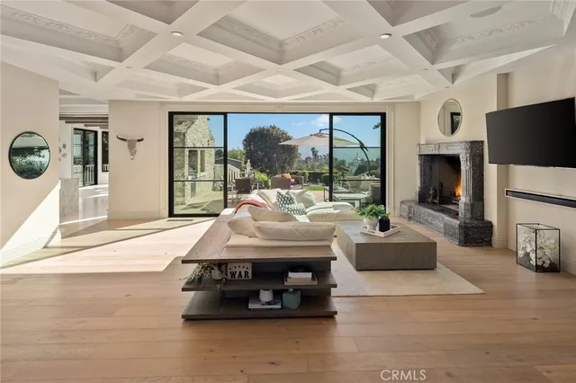 a living room with fireplace furniture and a floor to ceiling window