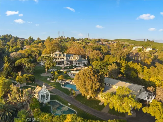 a front view of a house with a garden and swimming pool