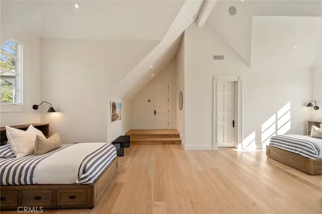 a view of a hallway with dining room and wooden floor