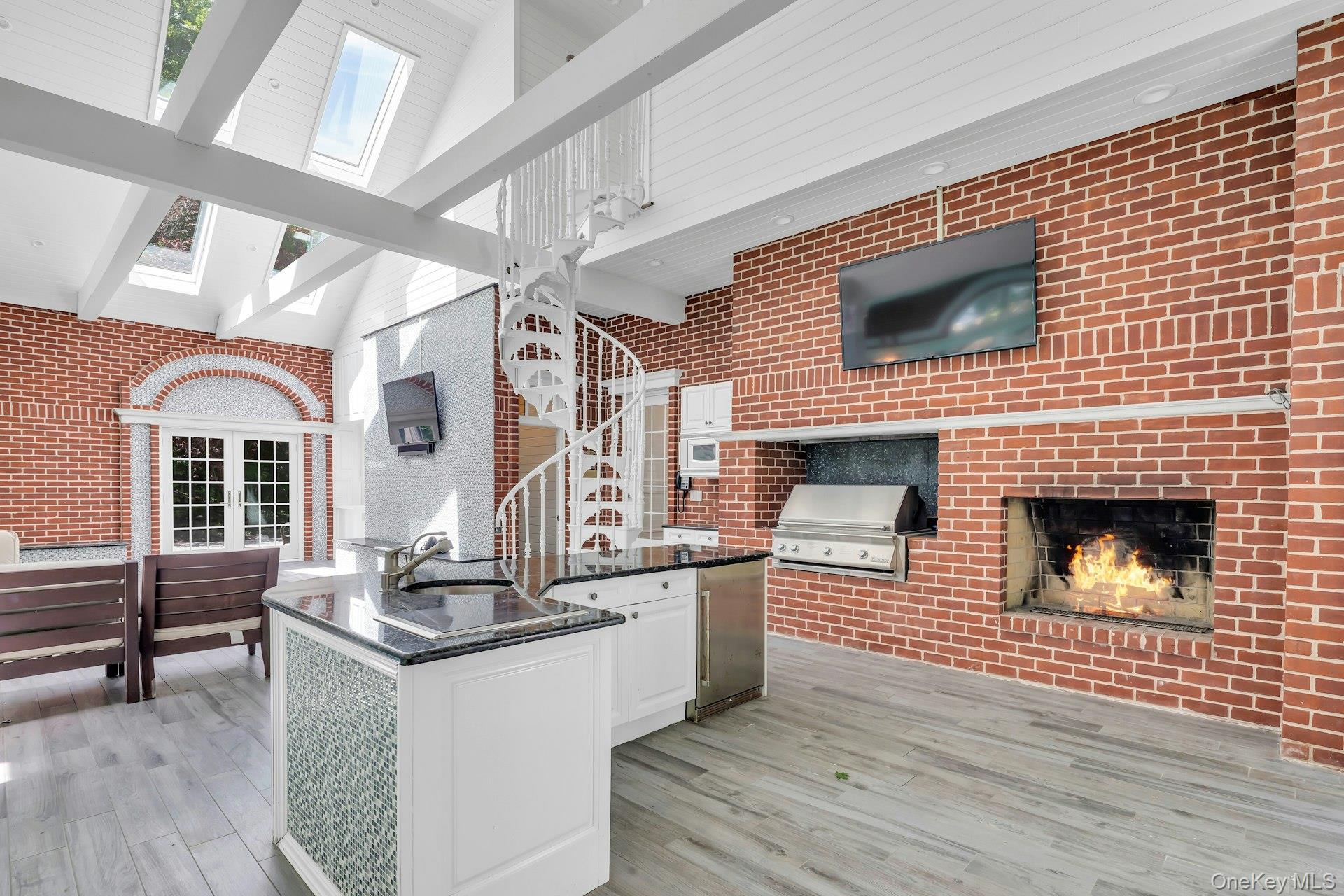 98 Cliff Road Port Jefferson, NY 11777 - Photo 23 of 47 Indoor bbq and Fireplace in Sunroom with full bath