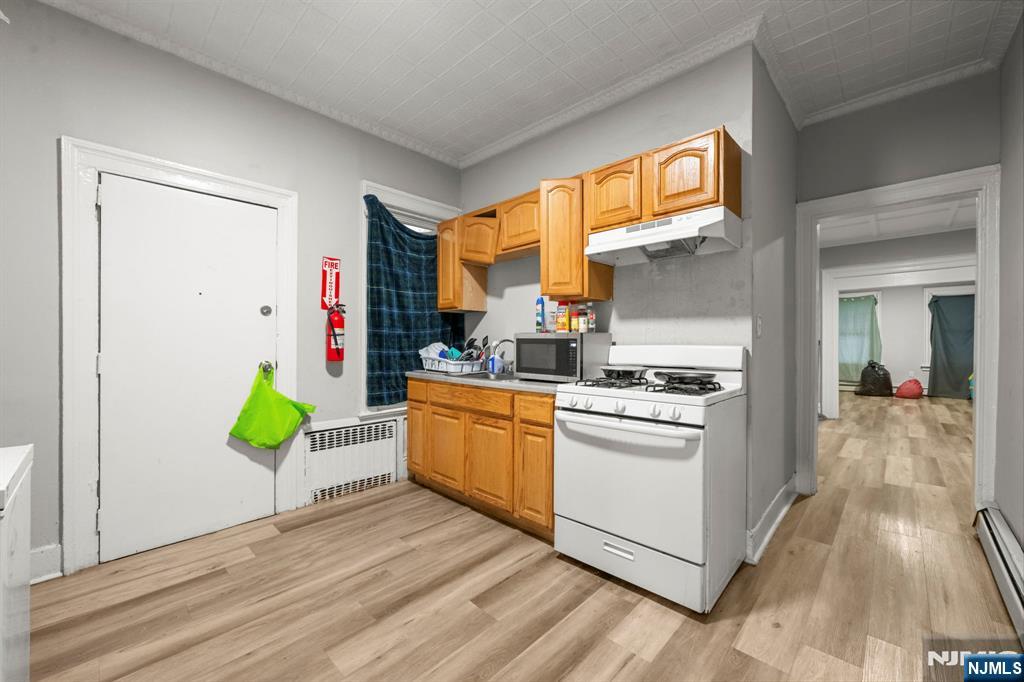 282 Hamilton Avenue Paterson, NJ 07501 - Photo 14 of 21 a kitchen with stainless steel appliances granite countertop a stove a sink and a window