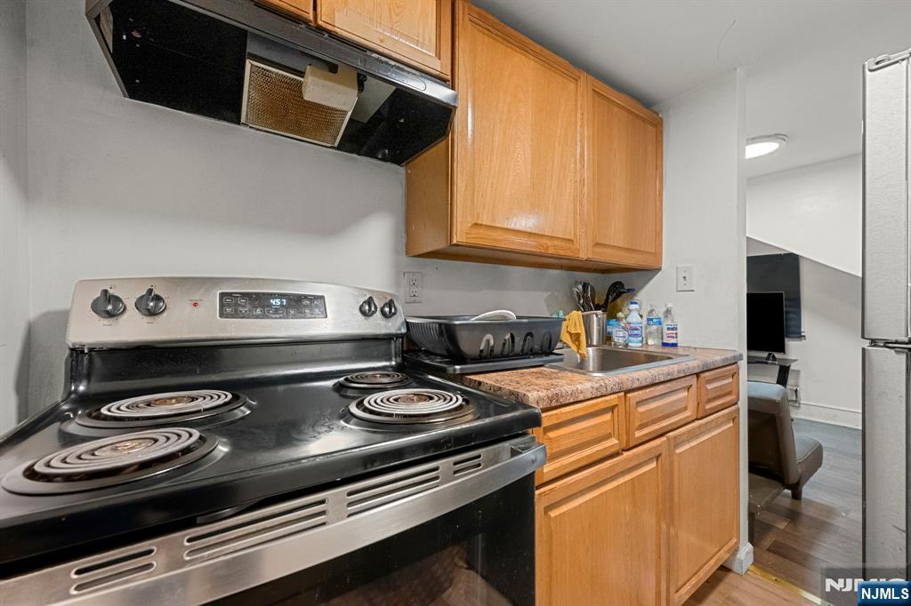 282 Hamilton Avenue Paterson, NJ 07501 - Photo 19 of 21 a kitchen with a stove and a microwave