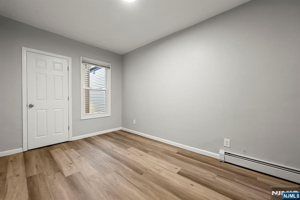 282 Hamilton Avenue Paterson, NJ 07501 - Photo 5 of 21 a view of room with window and hardwood floor