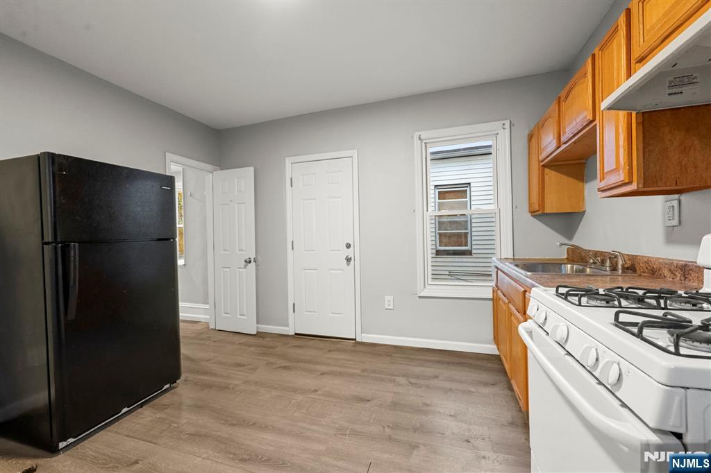 282 Hamilton Avenue Paterson, NJ 07501 - Photo 7 of 21 a kitchen with stainless steel appliances granite countertop a refrigerator and a stove