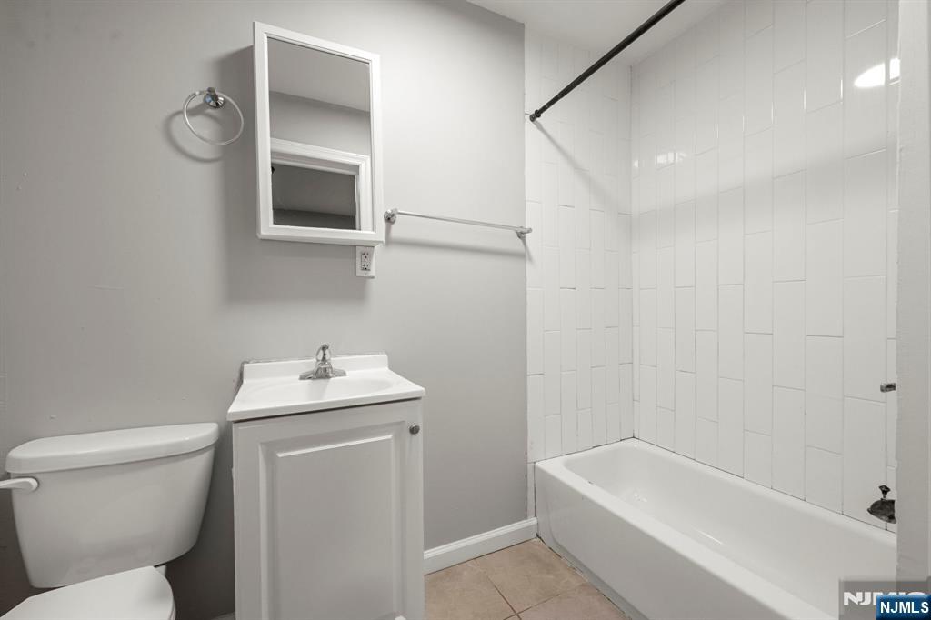 282 Hamilton Avenue Paterson, NJ 07501 - Photo 8 of 21 a bathroom with a sink toilet and bathtub