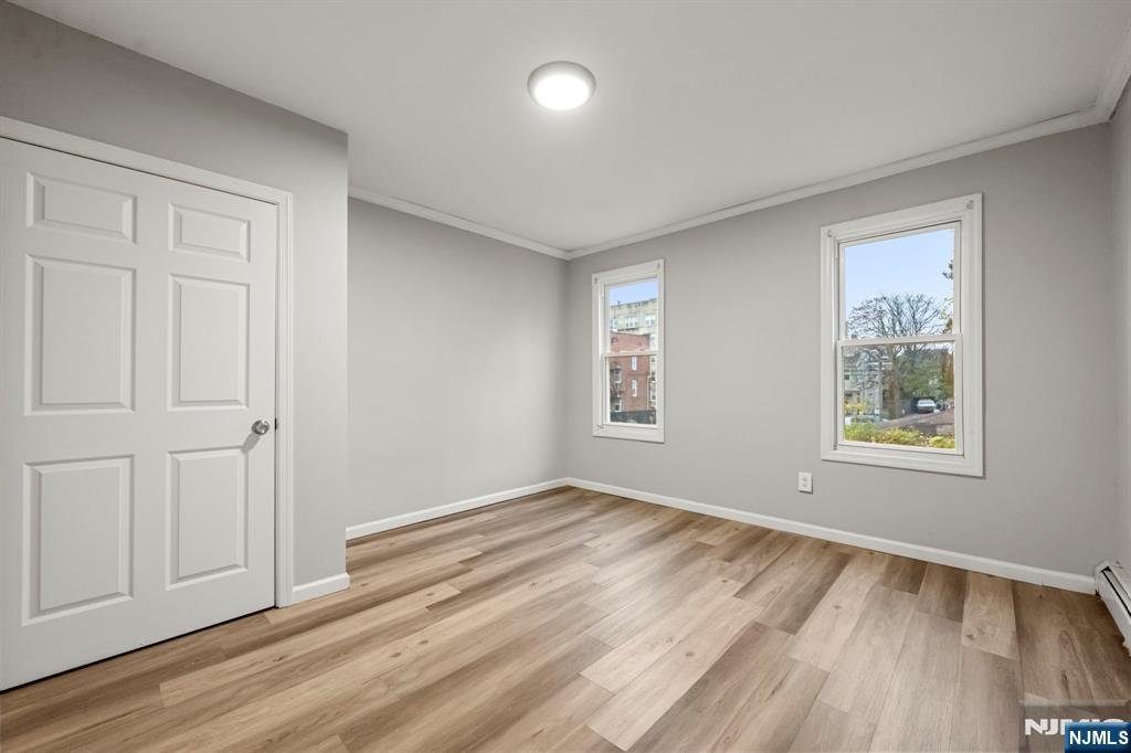 282 Hamilton Avenue Paterson, NJ 07501 - Photo 10 of 21 wooden floor in an empty room with a window