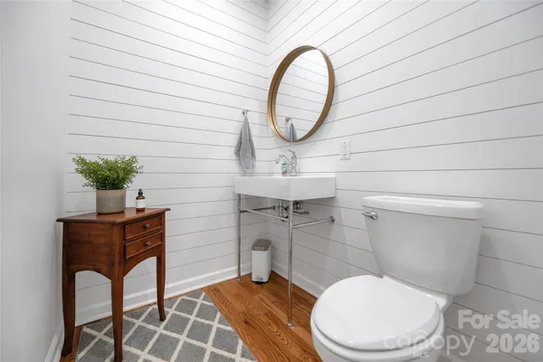 a bathroom with a toilet a sink and mirror