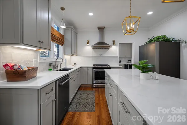 a kitchen with a sink stainless steel appliances and cabinets