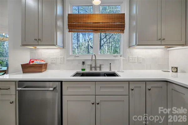 a kitchen with a sink cabinets and window