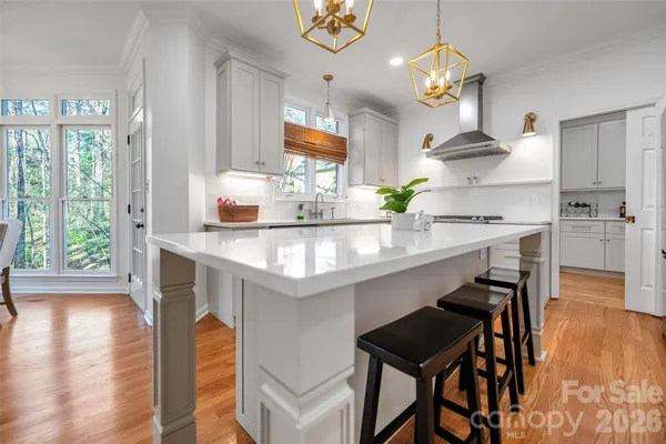 a kitchen with a table chairs sink and cabinets