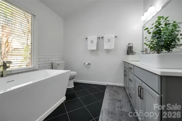 a bathroom with a sink a mirror and a bathtub