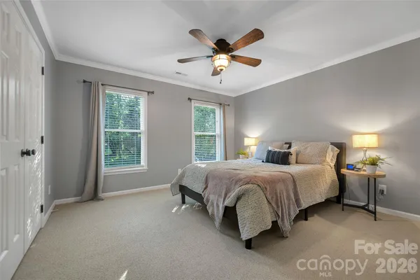 a spacious bedroom with a bed and window