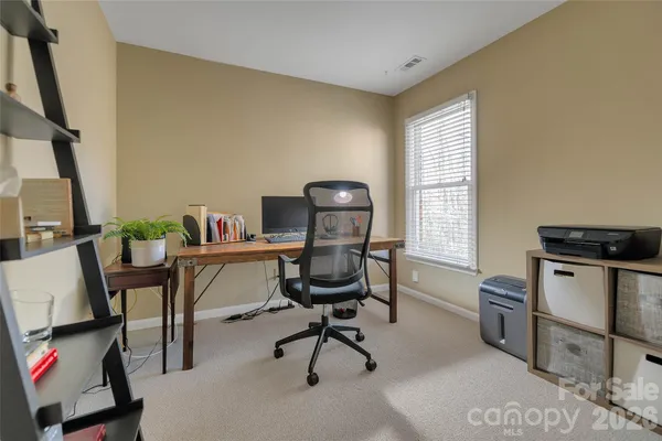 a workspace with wooden floor and windows