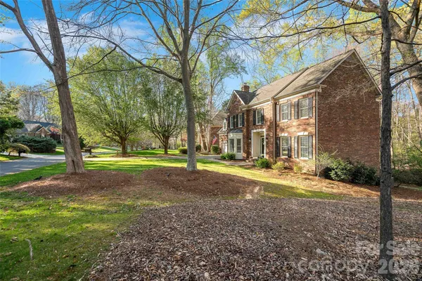 a view of a house with a yard and pathway