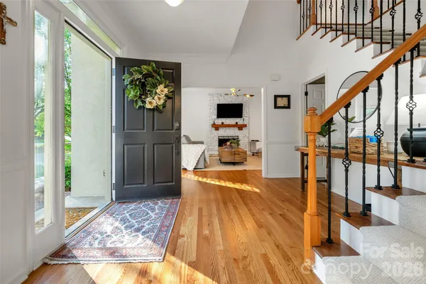 a view of entryway and hall with wooden floor