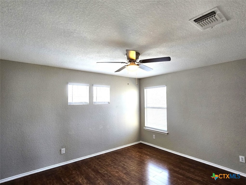 316 Julian Point Cibolo, TX 78108 - Photo 17 of 28 a view of an empty room with wooden floor and a window