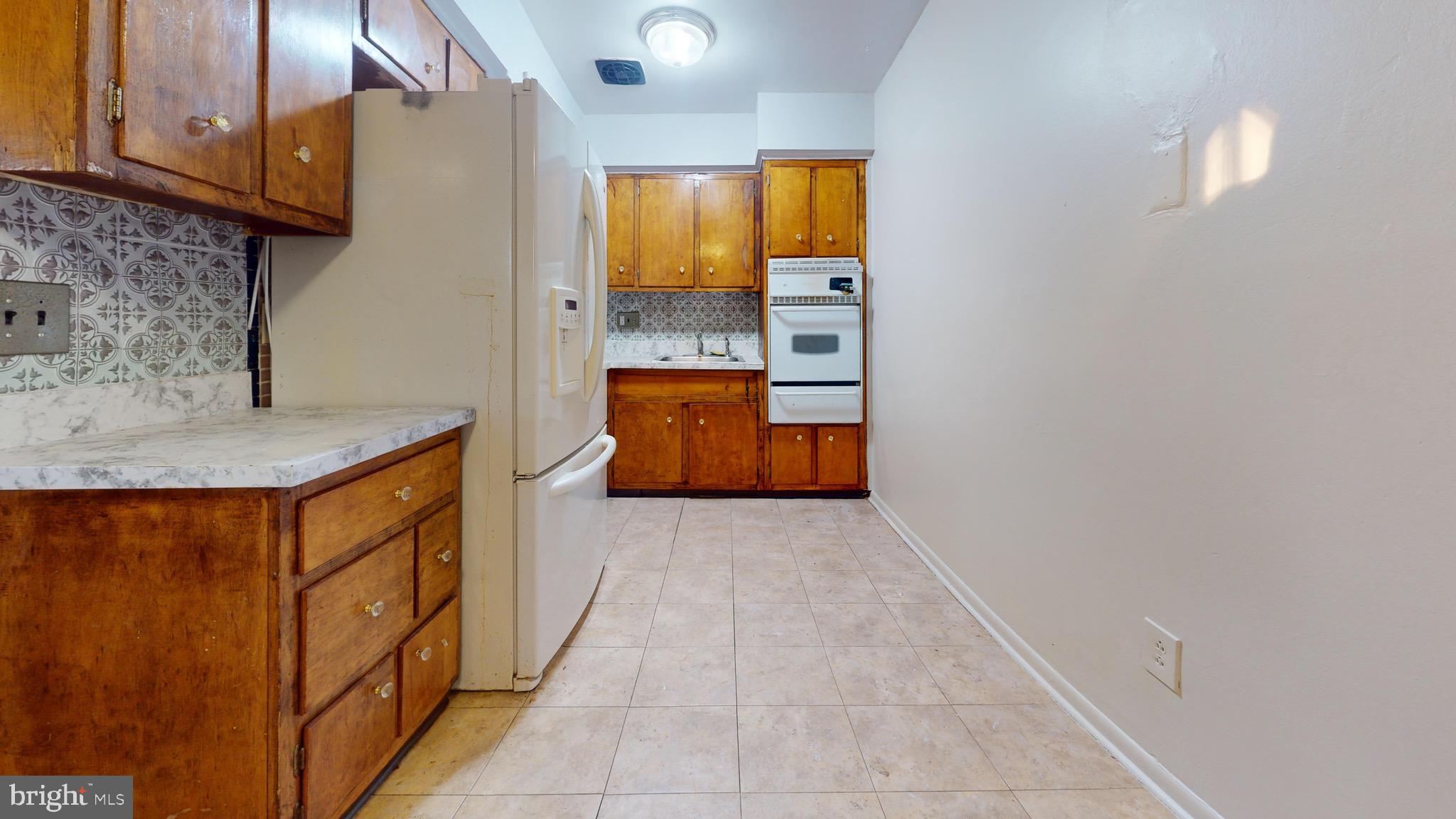 717 Red Lion Road, Unit 1 Philadelphia, PA 19116 - Photo 1 of 9 a hallway with washer dryer and cabinets