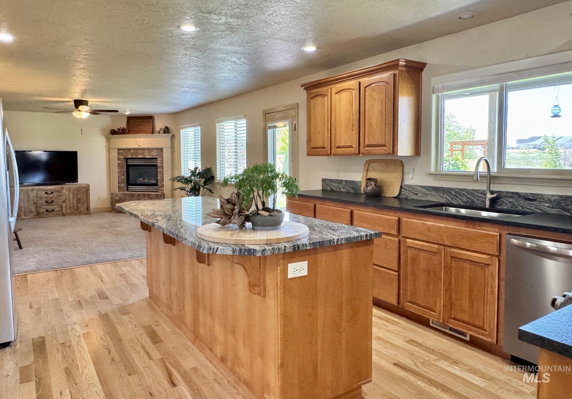 9299 Kemp Road Middleton, ID 83644 - Photo 10 of 50 Kitchen island with granite countertop and light wood cabinetry