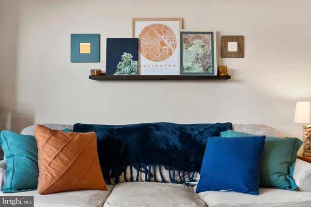a living room with furniture and painting on the wall