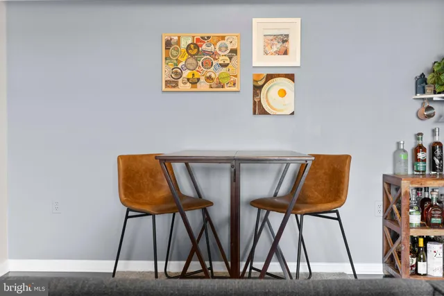 a view of an chairs and table in a room