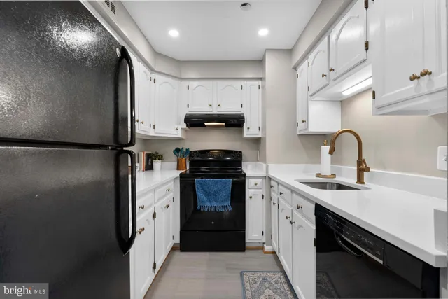 a kitchen with stainless steel appliances a sink stove and refrigerator