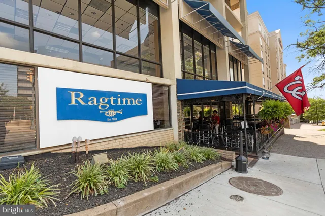 a view of a street with an entrance and sign board