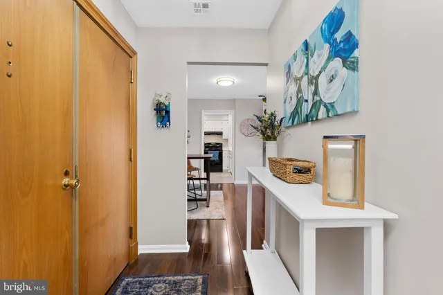 a view of entryway with furniture and wooden floor