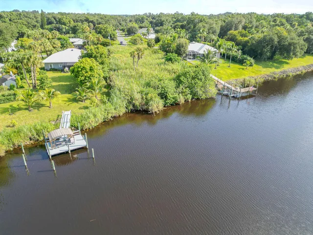 an aerial view of a house with swimming pool patio and outdoor seating