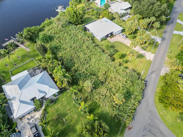 an aerial view of a house with swimming pool and garden