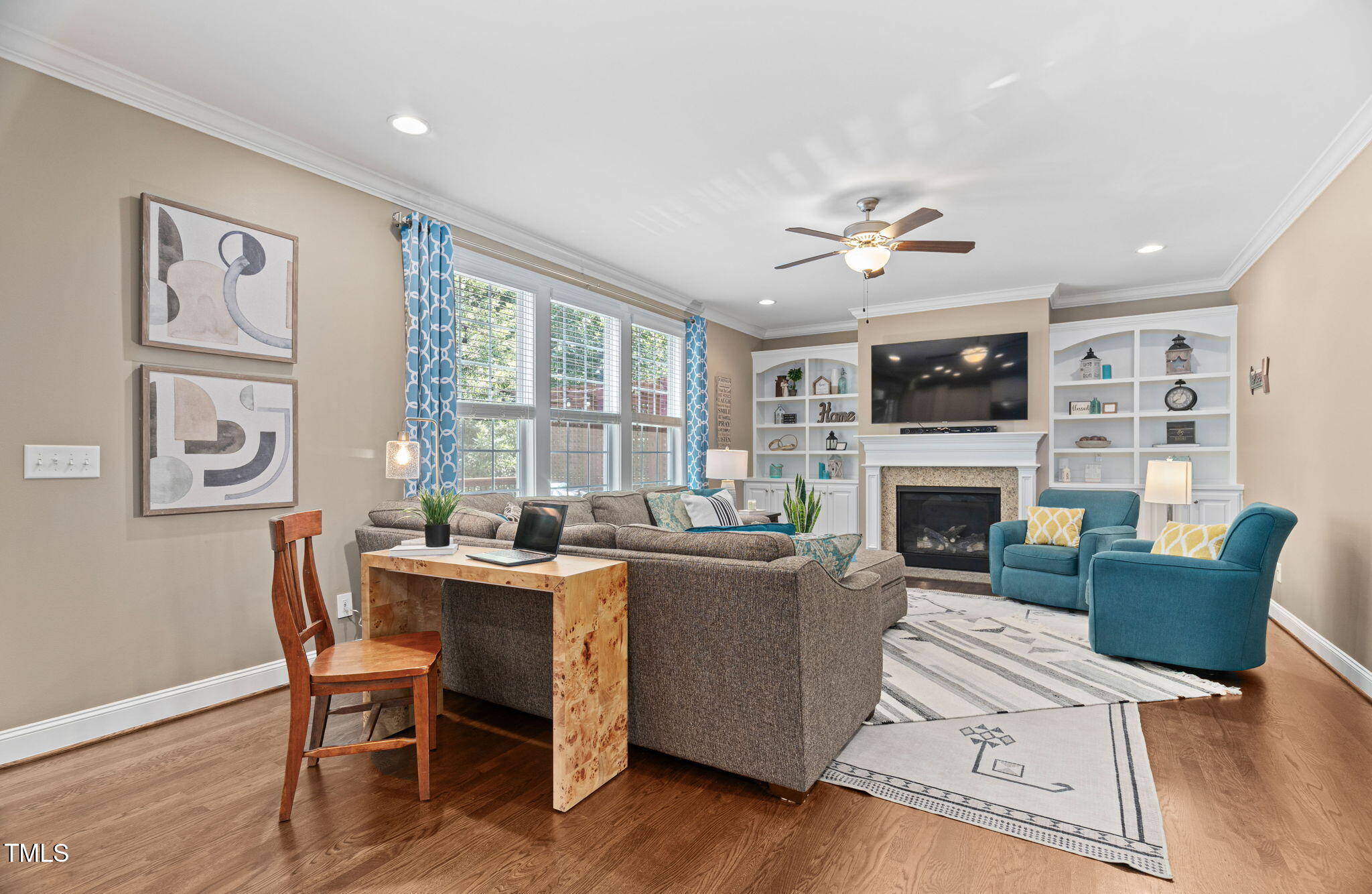2712 Lake Waccamaw Trail Apex, NC 27502 - Photo 11 of 41 a living room with furniture a fireplace and a large window
