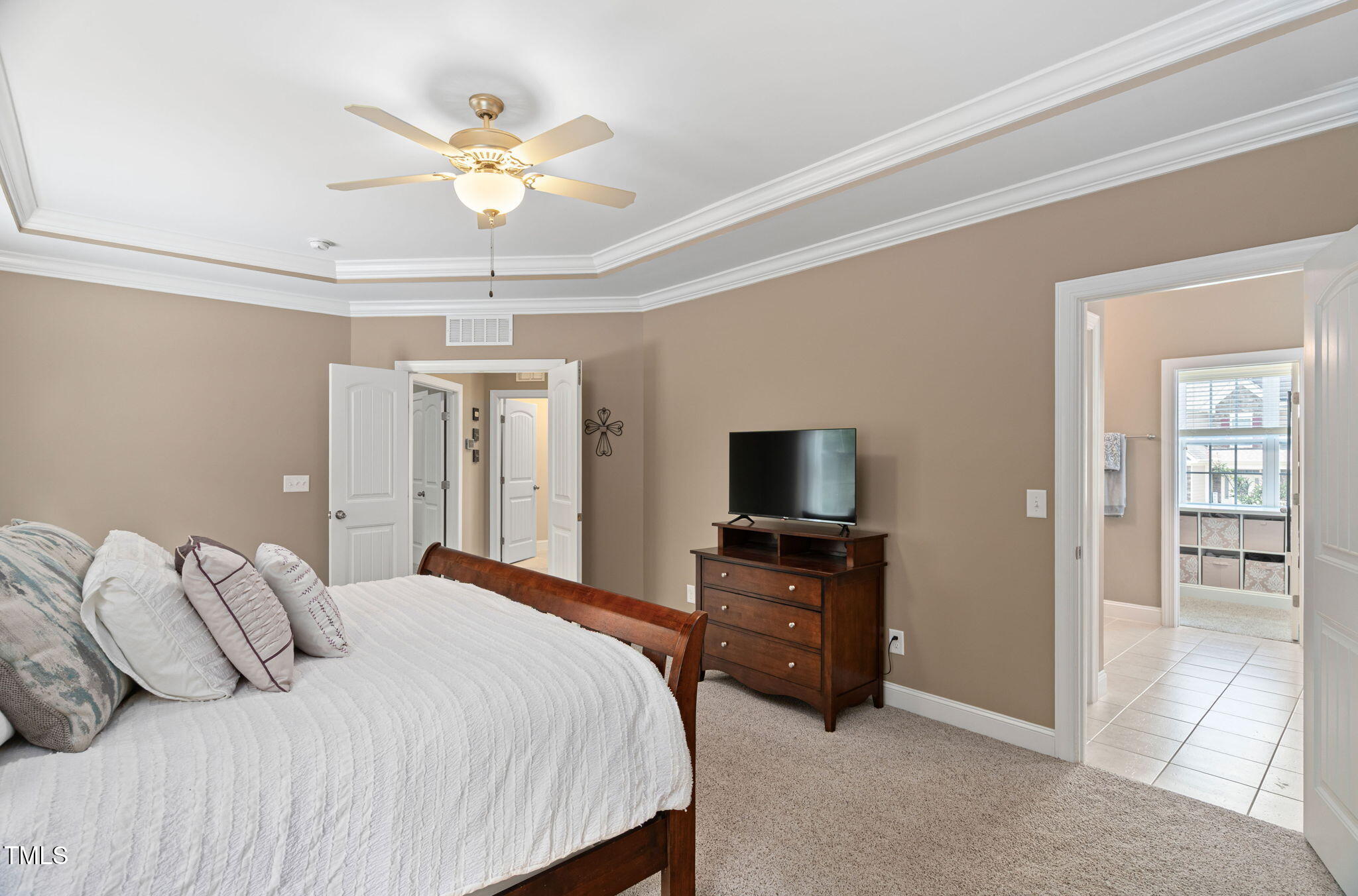 2712 Lake Waccamaw Trail Apex, NC 27502 - Photo 15 of 41 a bedroom with a bed and a flat screen tv