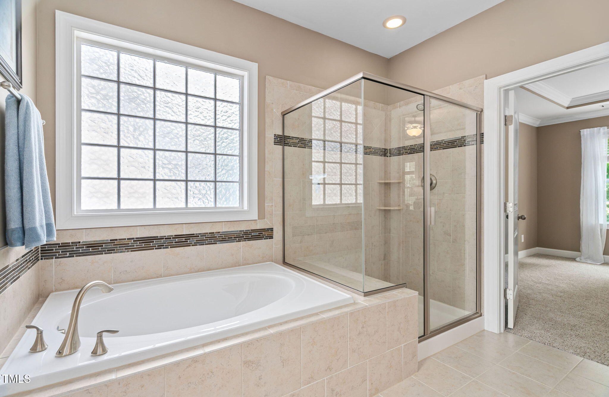 2712 Lake Waccamaw Trail Apex, NC 27502 - Photo 17 of 41 a bathroom with a bathtub and a shower