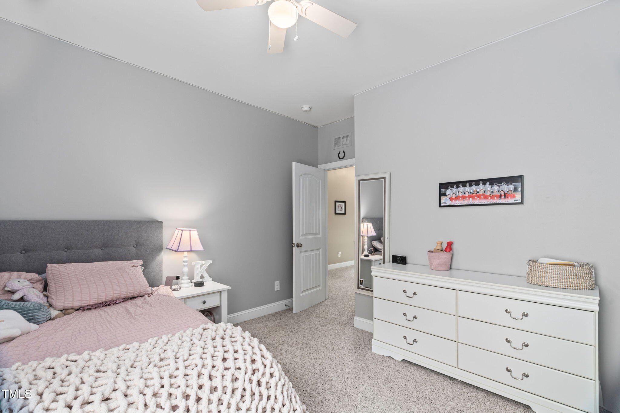 2712 Lake Waccamaw Trail Apex, NC 27502 - Photo 18 of 41 a bedroom with a bed and a dresser in it