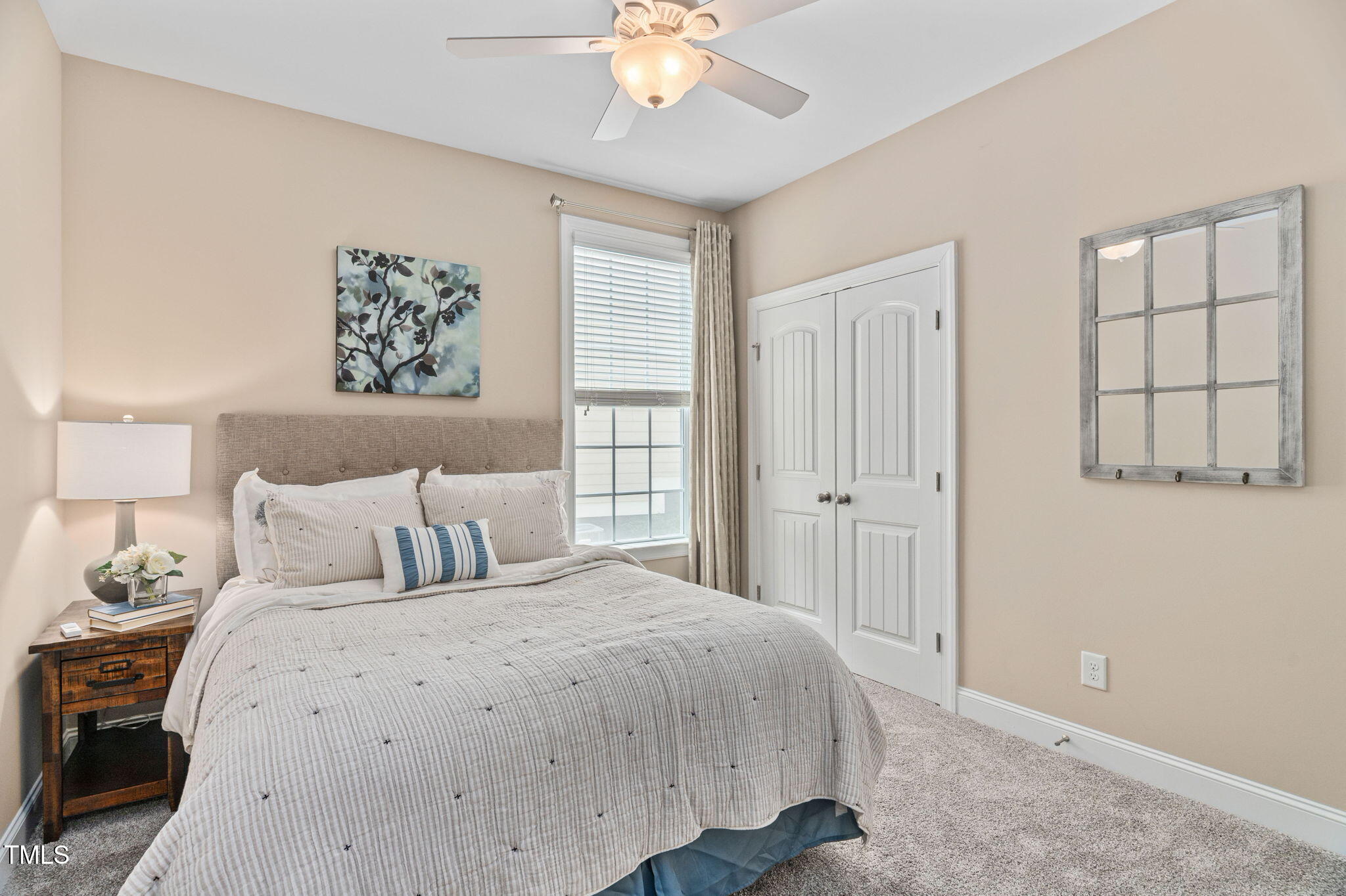 2712 Lake Waccamaw Trail Apex, NC 27502 - Photo 20 of 41 a bedroom with a large bed and a chandelier