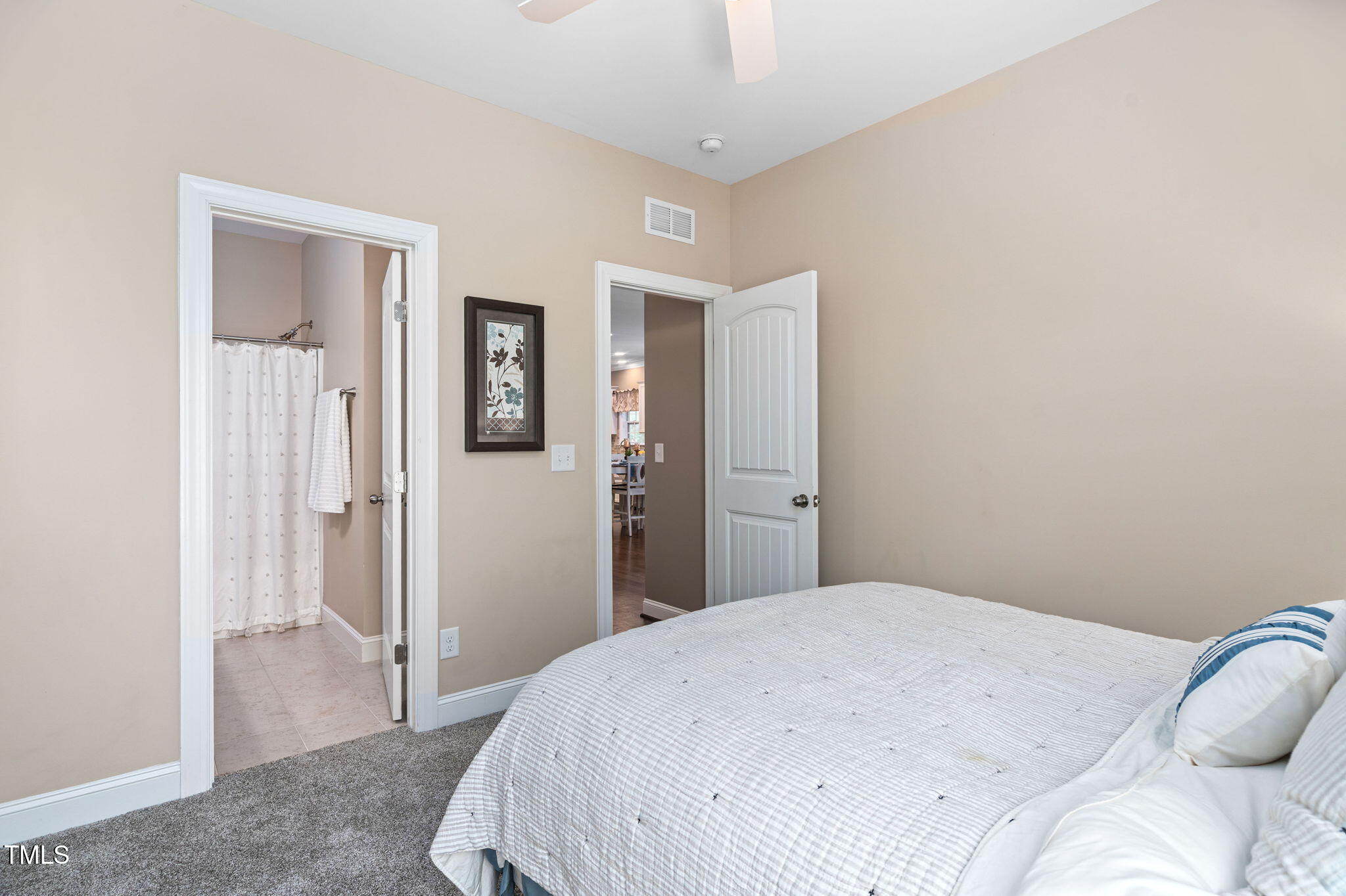 2712 Lake Waccamaw Trail Apex, NC 27502 - Photo 21 of 41 a bedroom with a bed and hallway