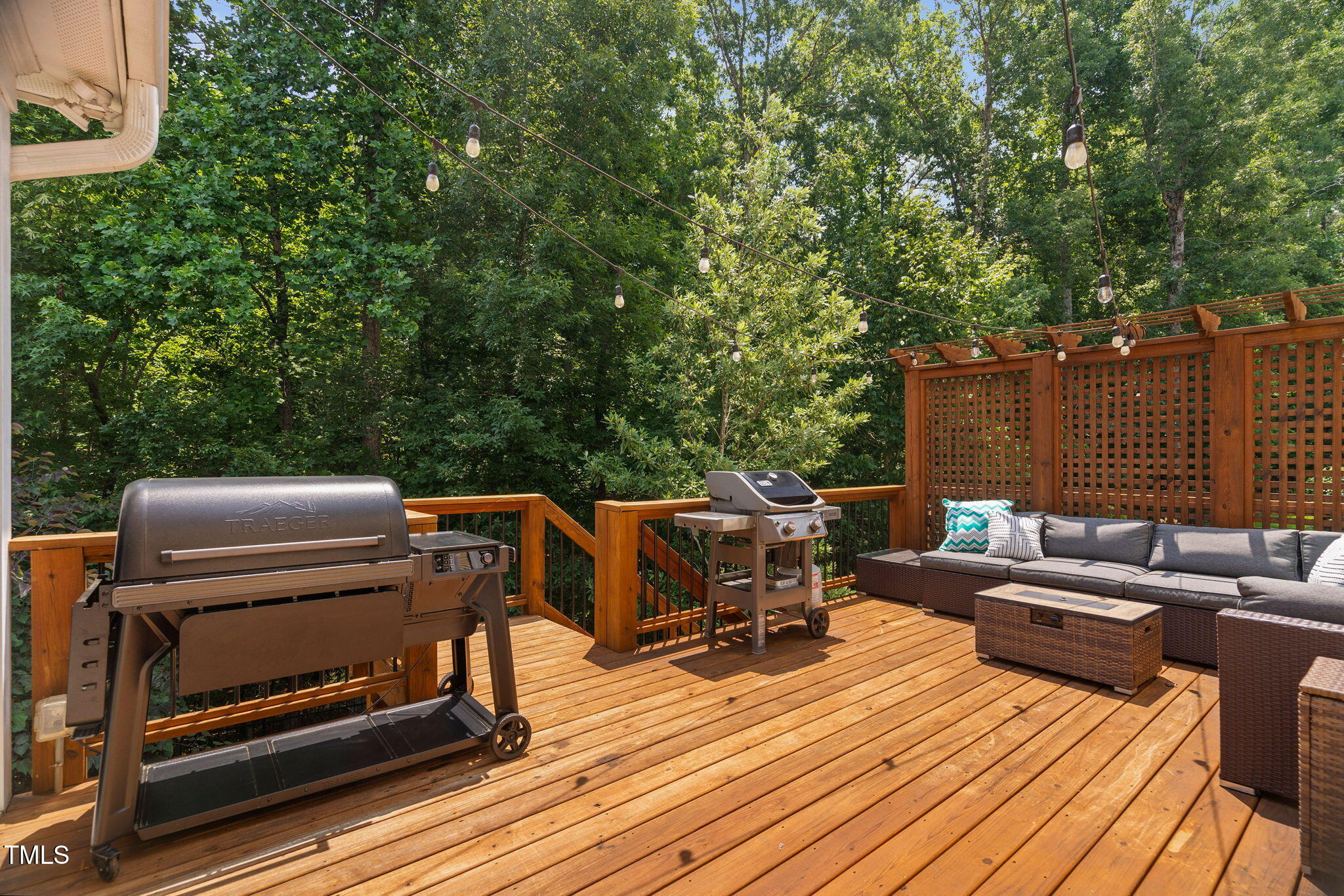 2712 Lake Waccamaw Trail Apex, NC 27502 - Photo 29 of 41 a view of a roof deck with couches fire pit and wooden fence