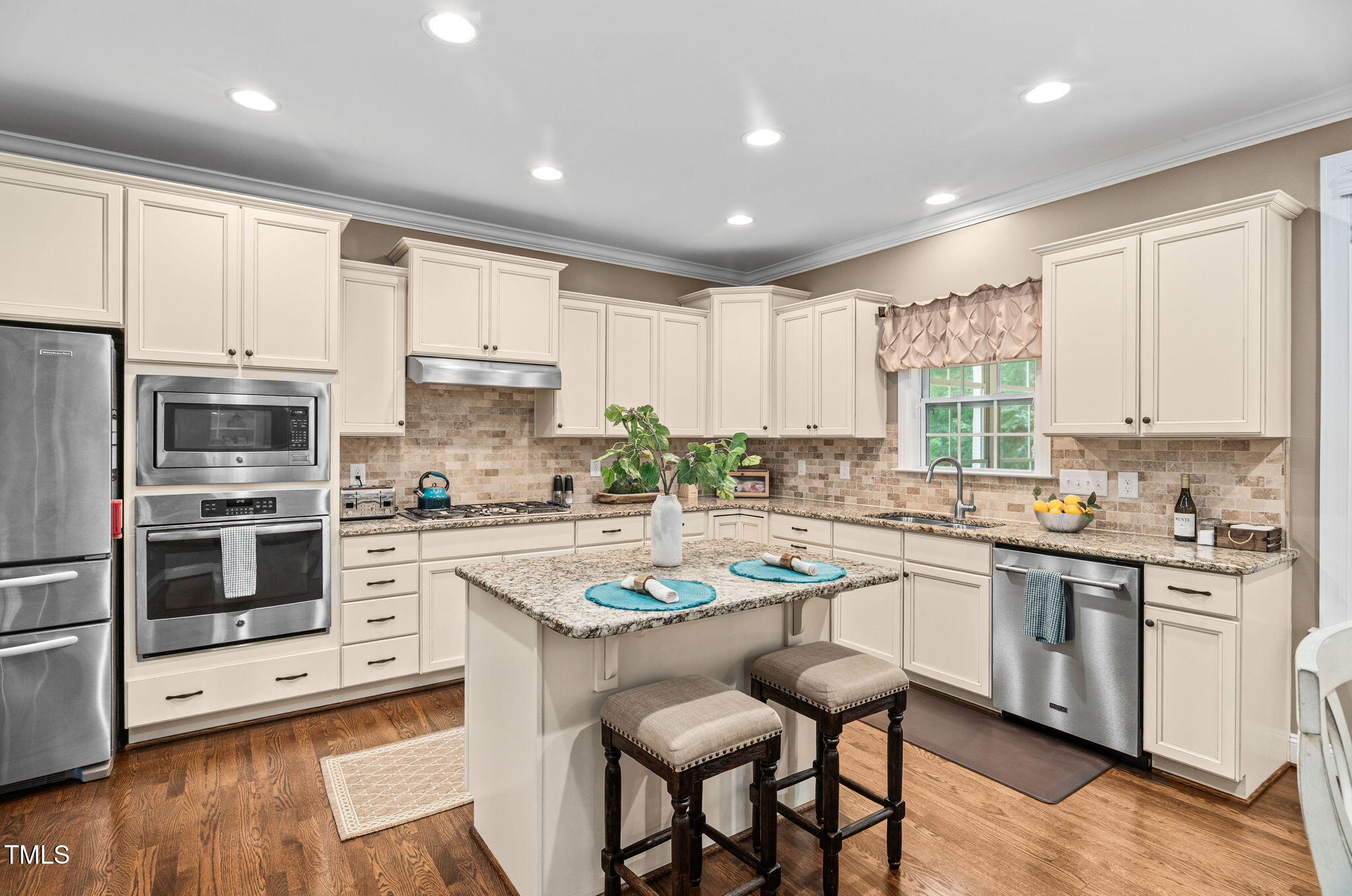 2712 Lake Waccamaw Trail Apex, NC 27502 - Photo 6 of 41 a kitchen with white cabinets and white appliances