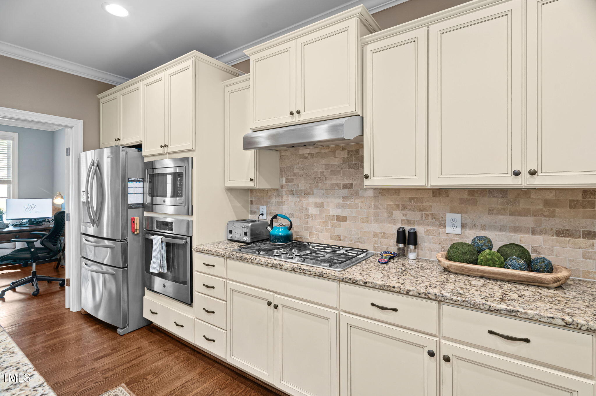 2712 Lake Waccamaw Trail Apex, NC 27502 - Photo 7 of 41 a kitchen with granite countertop white cabinets and stainless steel appliances